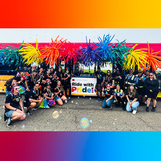 LBT Team Members in front of bus at Pride Parade LB 2022